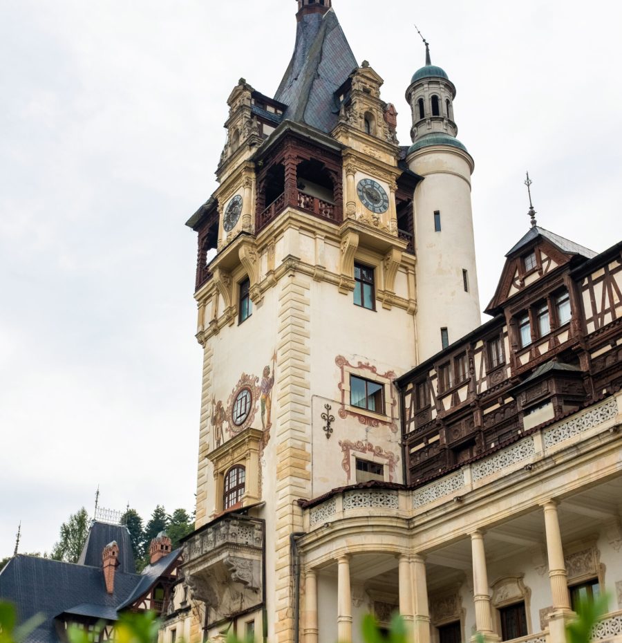 View of The Peles Castle in Romania. Castle with gardens and greenery in Carpathians